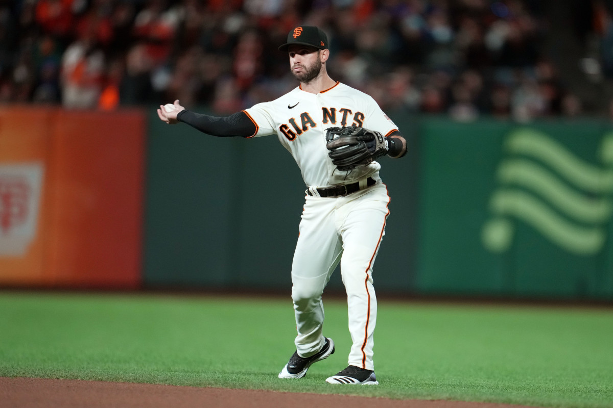 SF Giants infielder Tommy La Stella fields a grounder to second base.
